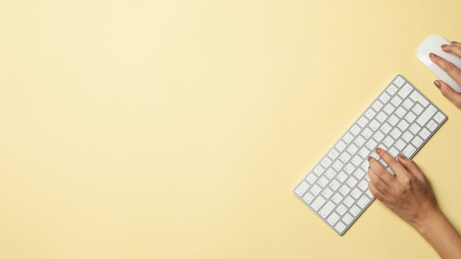 A woman typing on a keyboard.